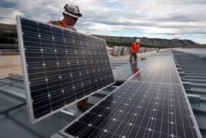 Workers installing solar panels