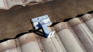 solar panel hardware being installed on a roof