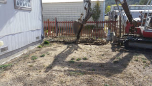 a backhoe that is digging a trench