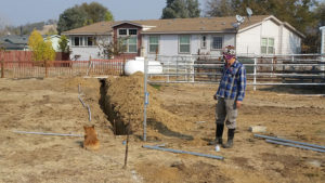 installing vertical metal pipes that will hold solar panels