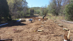 a pulled back view of digging a trench