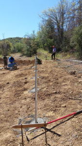 installing metal rods in ground for solar panels