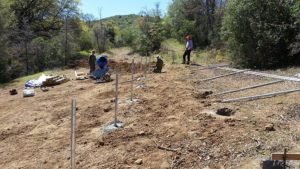 installing metal rods in ground for solar panels