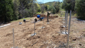 installing metal rods in ground for solar panels