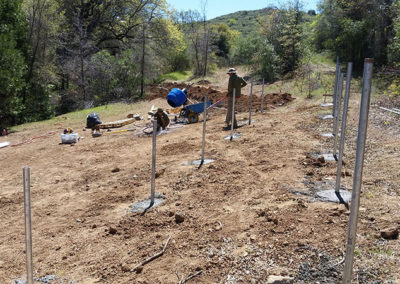 installing metal rods in ground for solar panels
