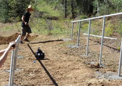 installing metal rods in ground for solar panels